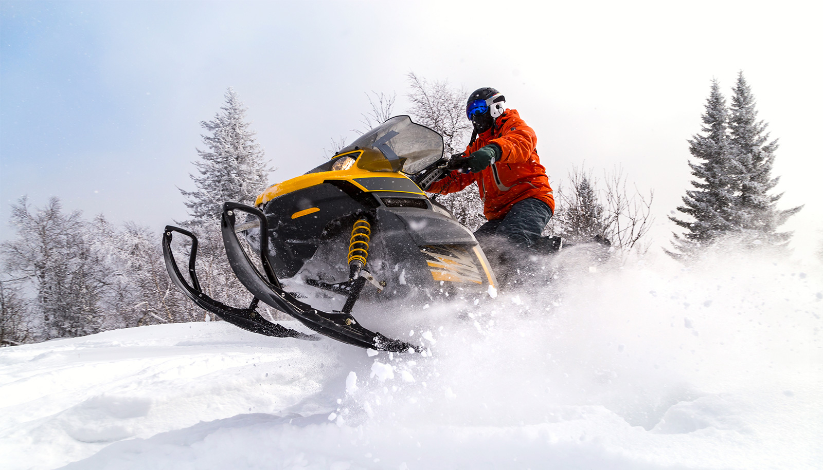 Snowmobile plowing through the snow